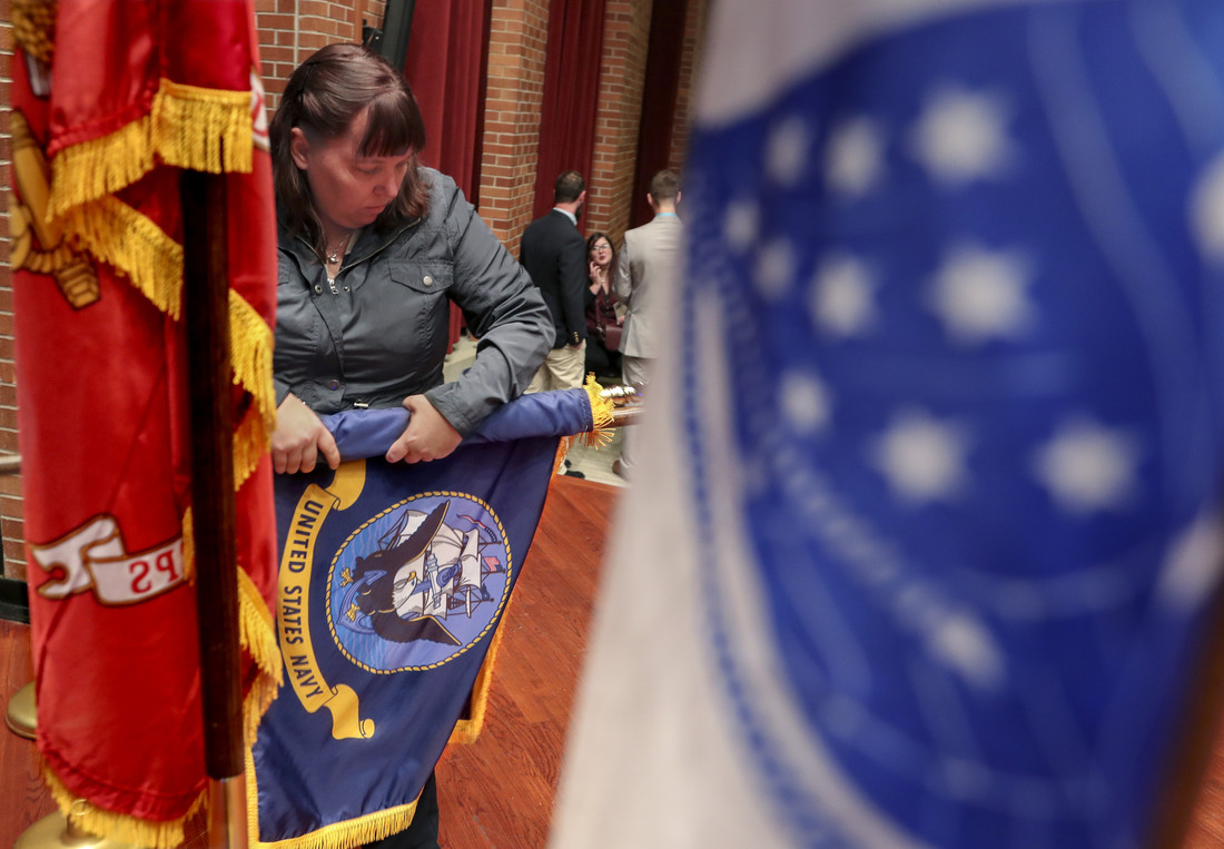 Military Student Success Center Assistant Director and Coast Guard veteran Cheryl Kleeman prepares flags for the Nov. 12 ceremony.