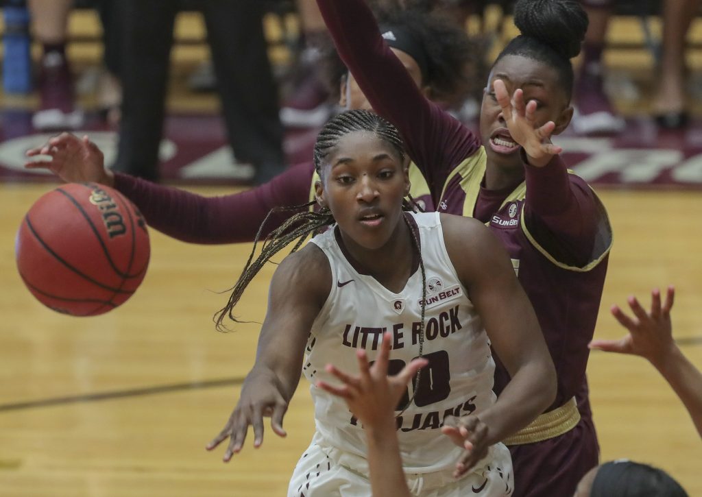 UA Little Rock forward Raeyana DeGray is surrounded by Texas State defenders during the Trojan’s game at the Jack Stephens Center. Photo by Benjamin Krain.