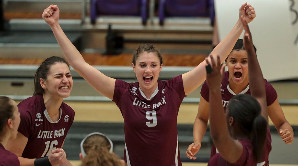 Taylor Lindberg (No. 5) celebrates with her fellow volleyball players.