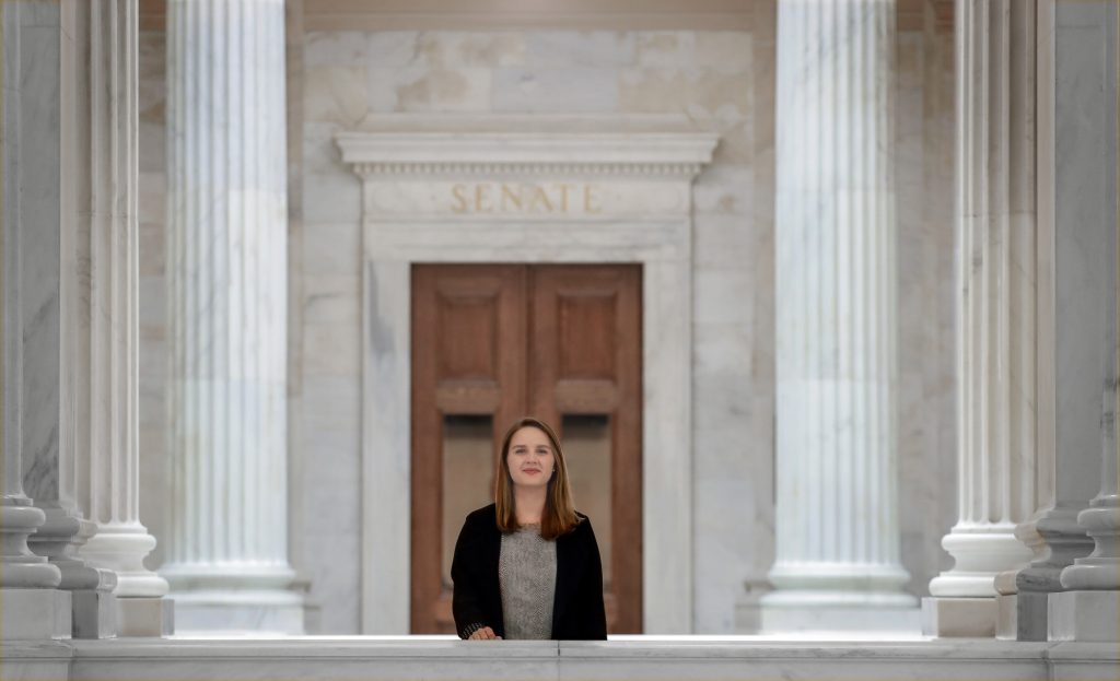Julia O'Hara, who is graduating from UA Little Rock with a bachelor's degree in political science, stands outside the Senate chambers in the Arkansas State Capitol building. Photo by Ben Krain. 