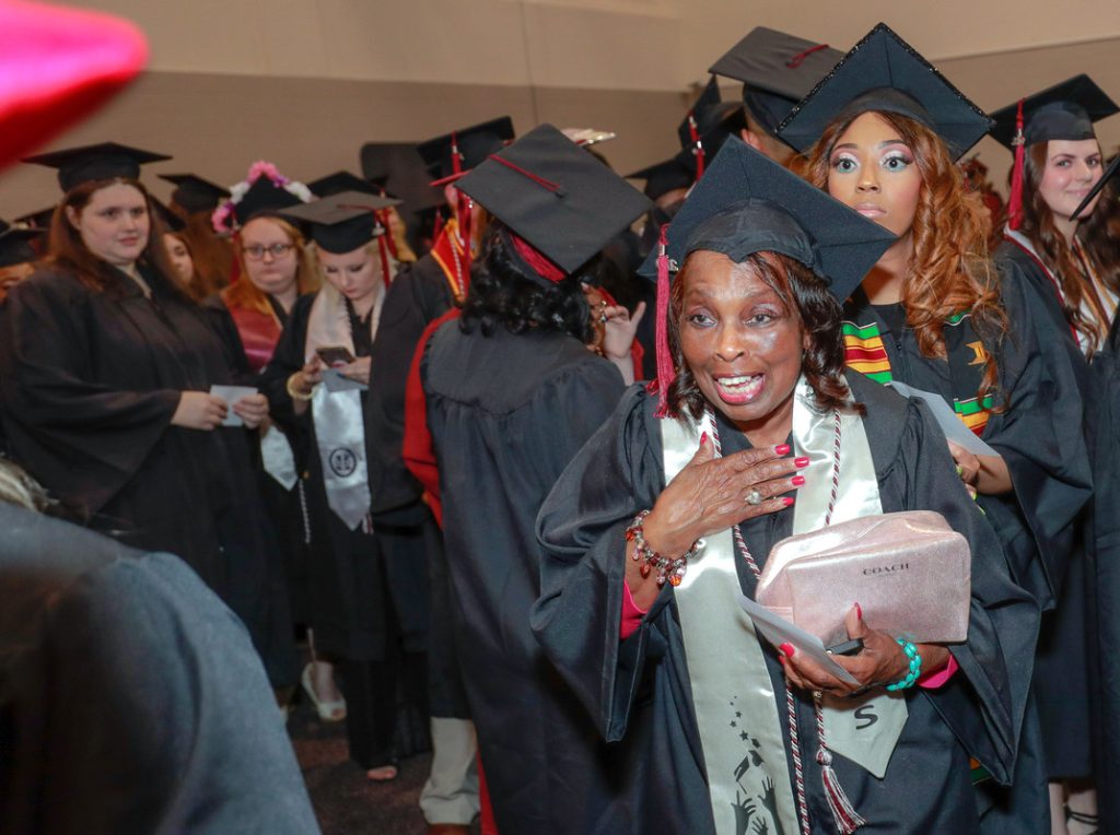 Graduate Vivian Littrell, right, reacts reacts in shock after her niece Chauntee Coleman, off camera at left, makes a surprise visit to Littrell's graduation ceremony at UA Little Rock on May 11. Photo by Ben Krain. 