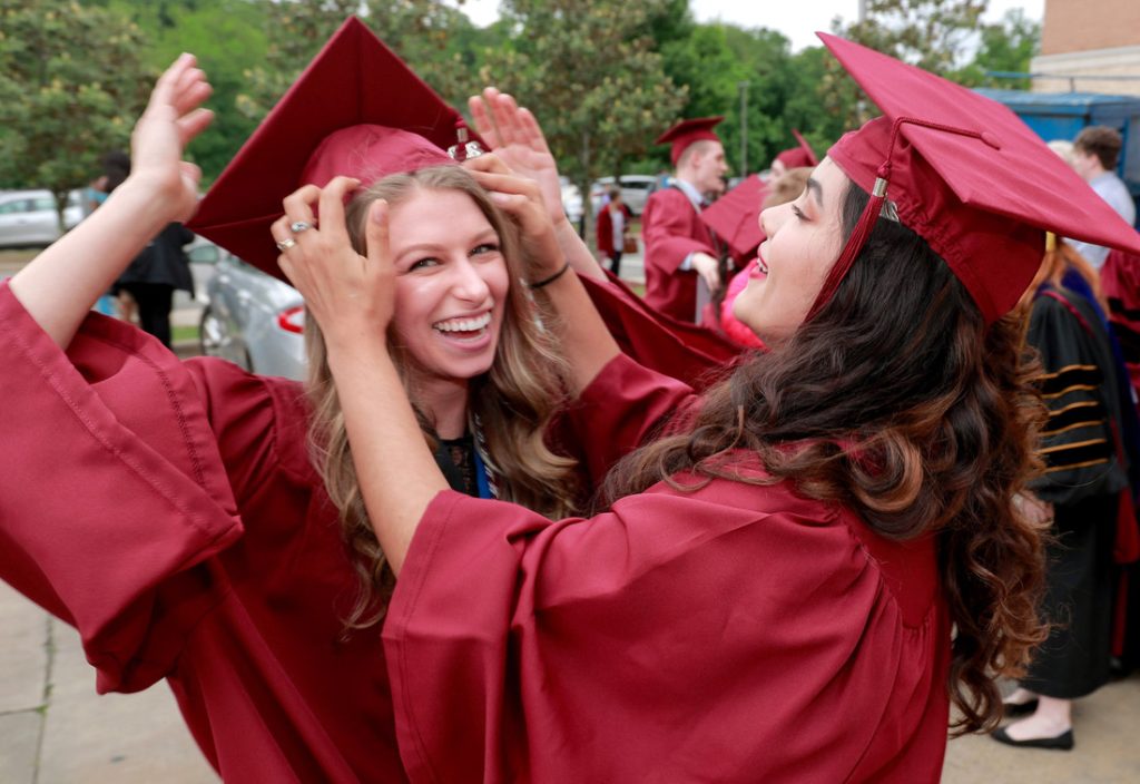 UA Little Rock Donaghey Scholars and best friends Ingrid Helgestad, left, and Abby Resendiz, right, congratulate each other after their commencement ceremony May 11. Photo by Ben Krain. 