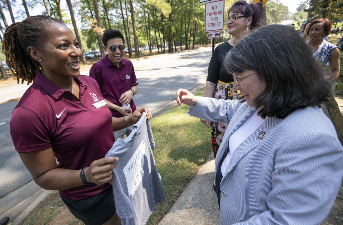 Chancellor Christina Drale (right) receives a t-shirt from Kristi Smith at BBQ at Bailey. Photo by Ben Krain.