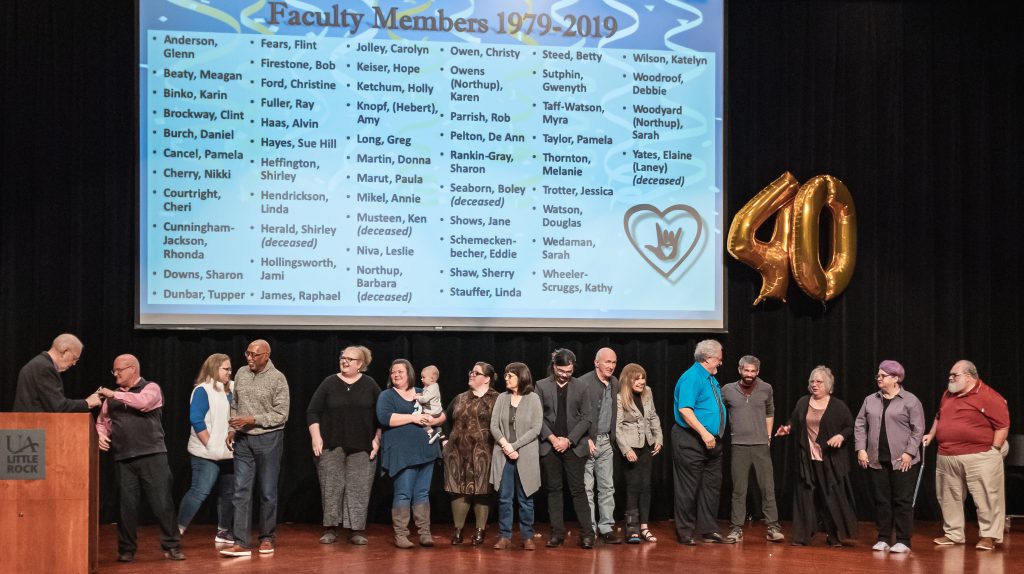 Northrup and Schmeckenbecher celebrate the 56 faculty members who have contributed to the UA Little Rock Interpretation Education Program since 1979. Photo by Brad Simms.