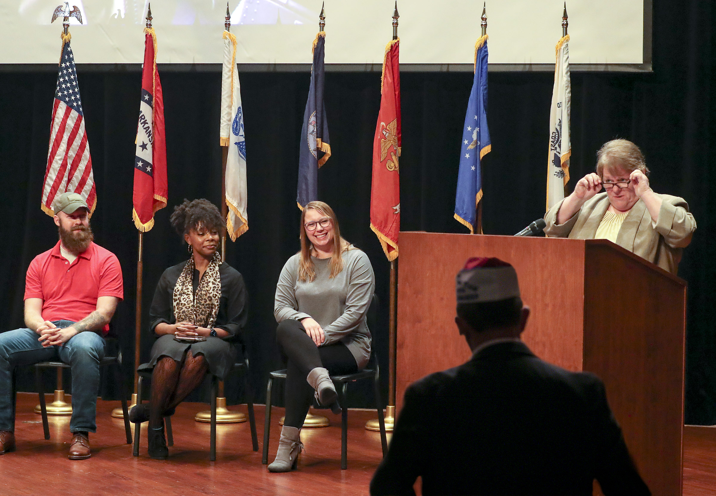 Kathy Oliverio right, honors UA Little Rock student veterans, from left, Sean Lewis, Alexis Harris, and Kaycee Greenwood, who participated in a Veterans Day ceremony. Photo by Ben Krain.