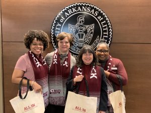 Members of the Office of the Chancellor receive tote bags after participating in the Campus Campaign. 