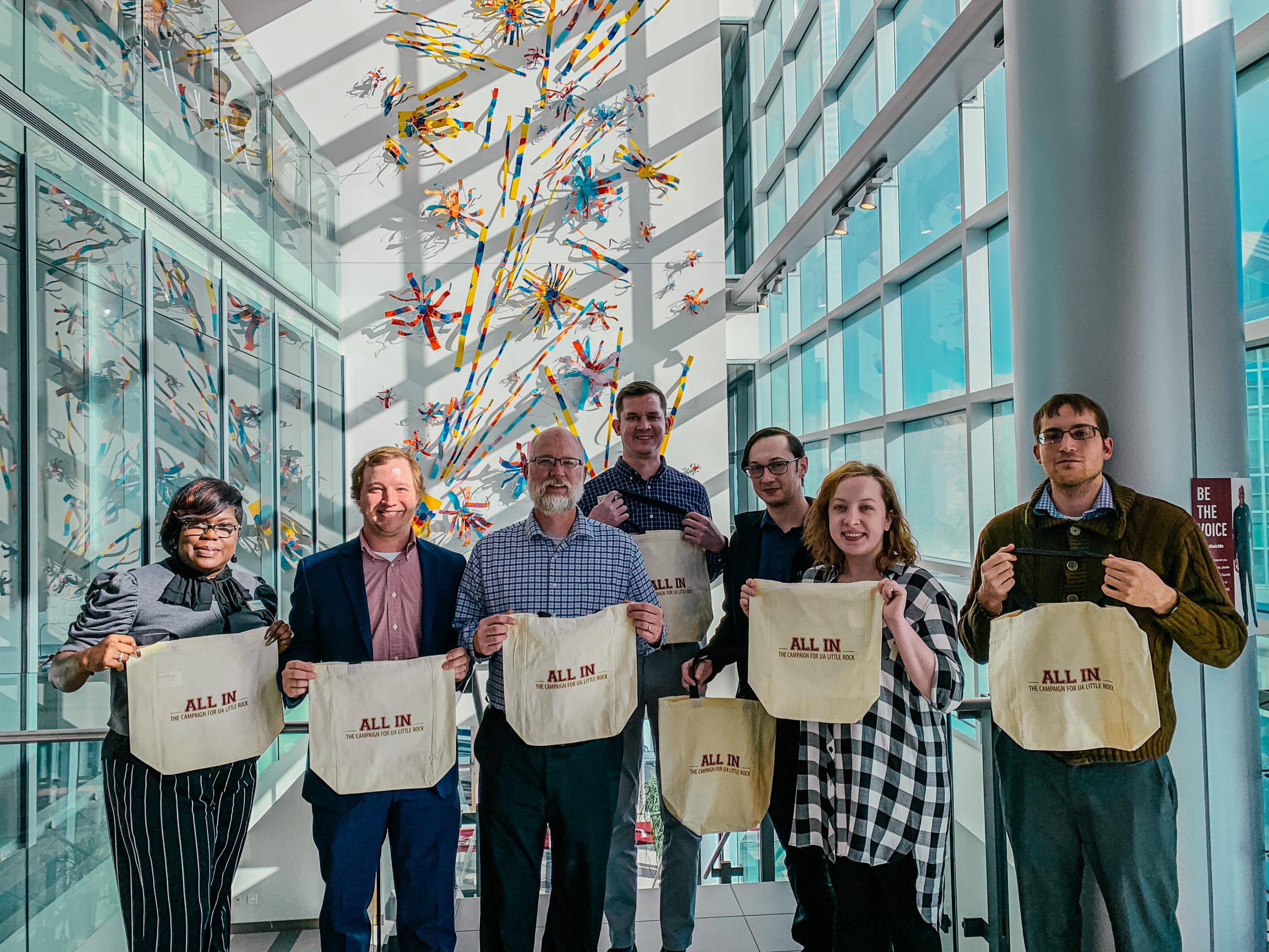 UA Little Rock employees in the Office of Financial Aid receive tote bags after completing 100 percent participation in the Campus Campaign.