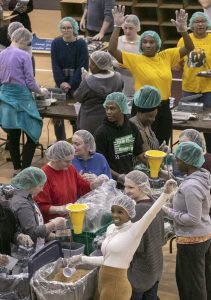 UA Little Rock students, faculty, and staff fill ready-to-cook meal bags during a Feed-the-Funnel philanthropy event facilitated by The Pack Shack hunger relief charity. Participants made 10,000 meals which will be donated to the Trojan Food Pantry. Photo by Ben Krain.