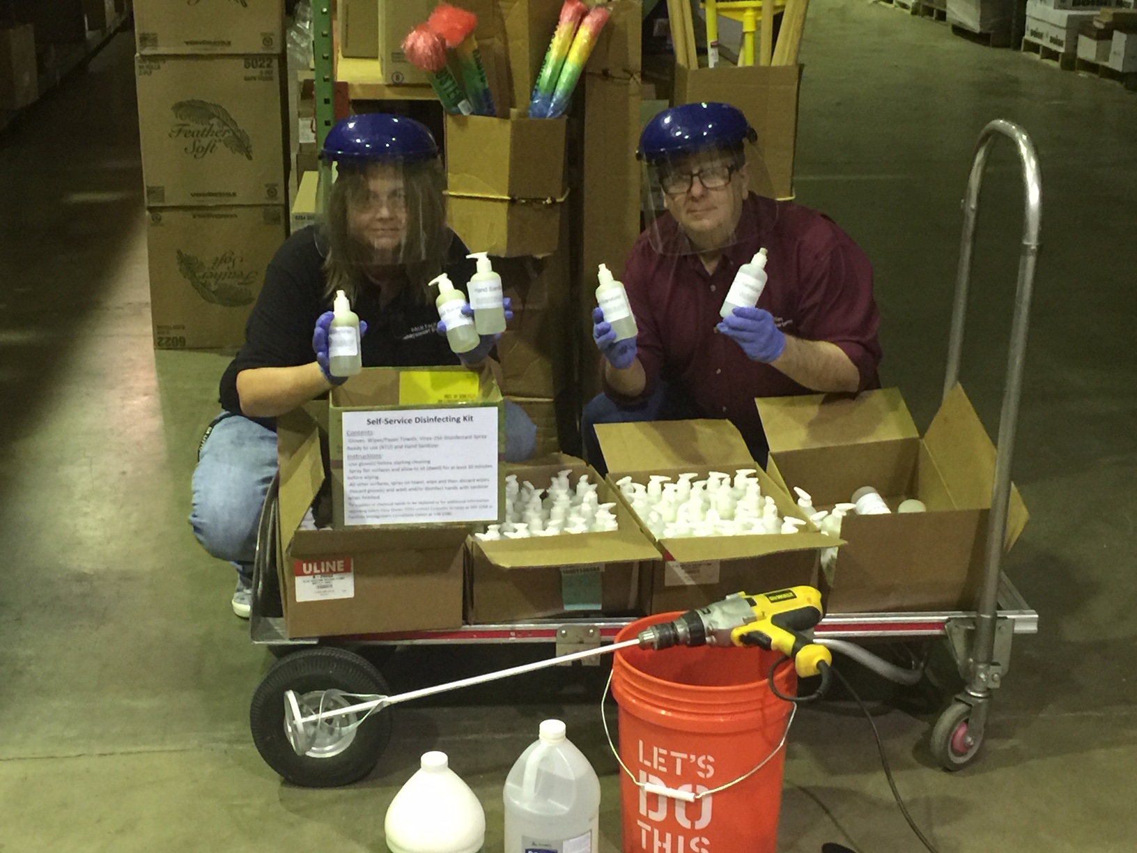 Sandra Vail, left, and Vince Rodgers, right, transport the hand sanitizers made by Facilities Management for use on the UA Little Rock campus.