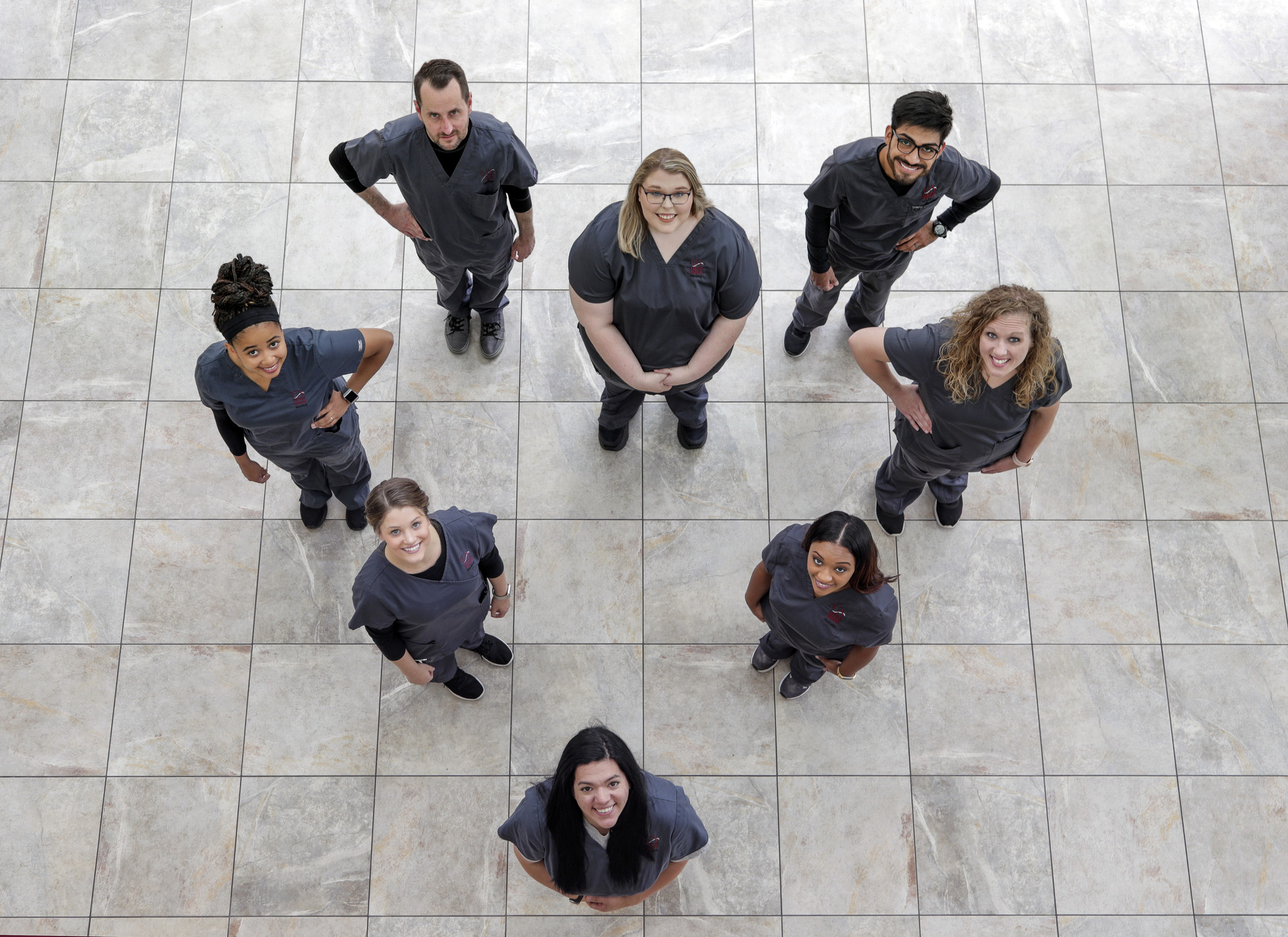 UA Little Rock nursing students stand in the shape of a heart.