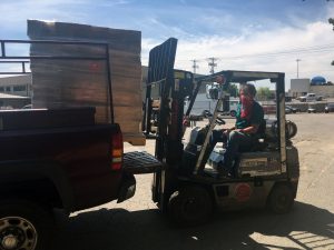 Michael Seamon, assistant director of operations in facilities management, unloads a donation of hand sanitizer from Peach Layne.