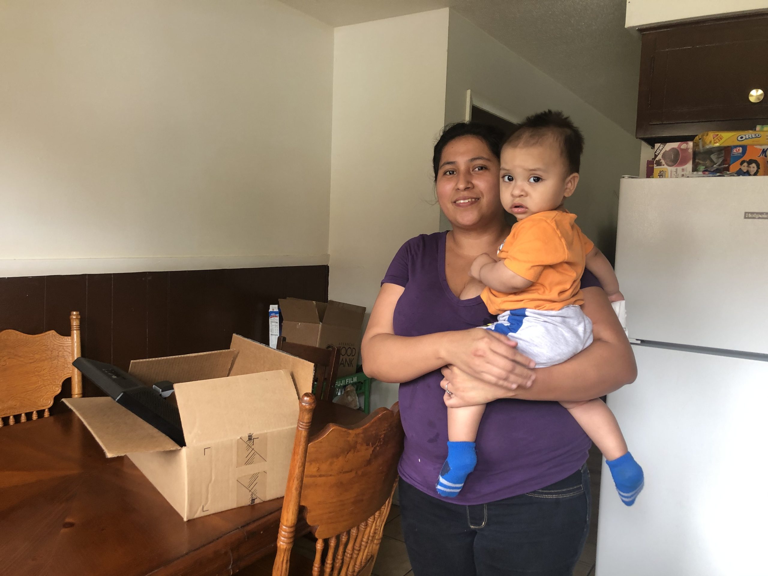 A mother who received a computer donated from UA Little Rock employees and students.