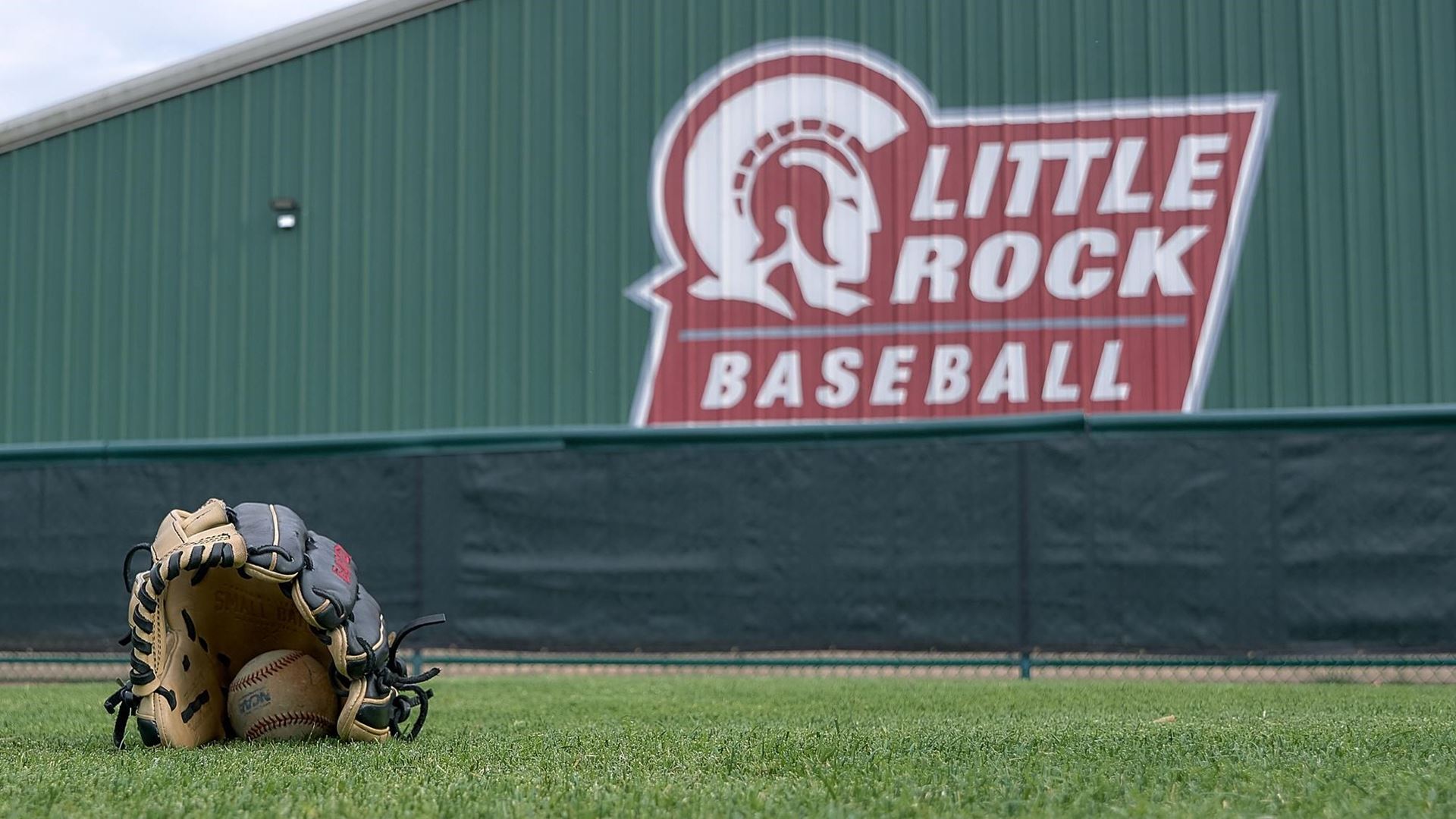 A baseball and glove are shown on Gary Hogan Field.