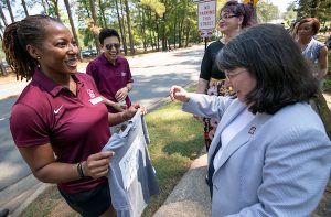 Kristi Smith presents a t-shirt to Chancellor Christina Drale during the 2019 BBQ at Baileys event. Photo by Ben Krain.