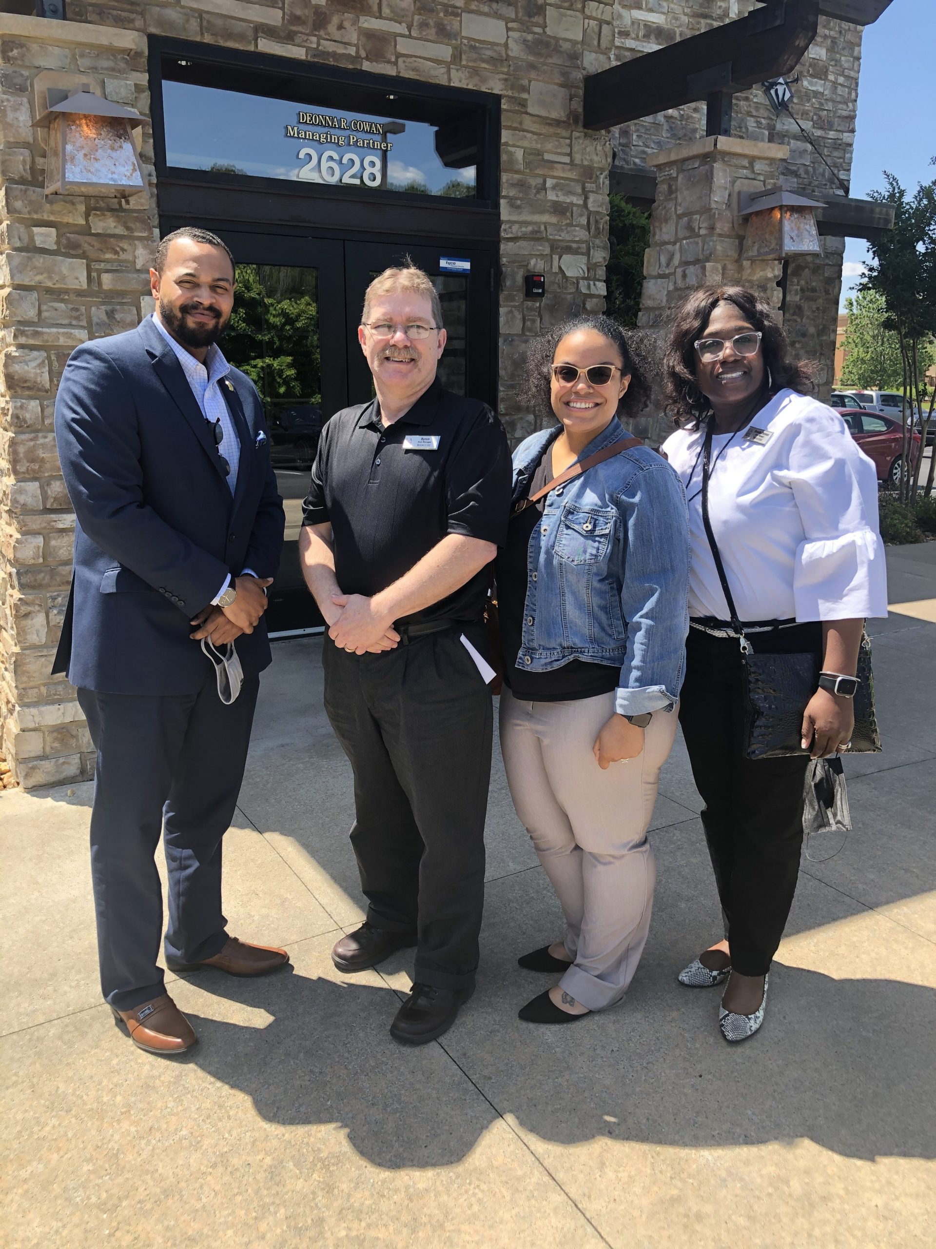 Longtime UA Little Rock Bookstore employee Byron Barger, center, celebrates his retirement with Richard Harper, left, Kristin Nelson, center, and Brenda Thomas, right.