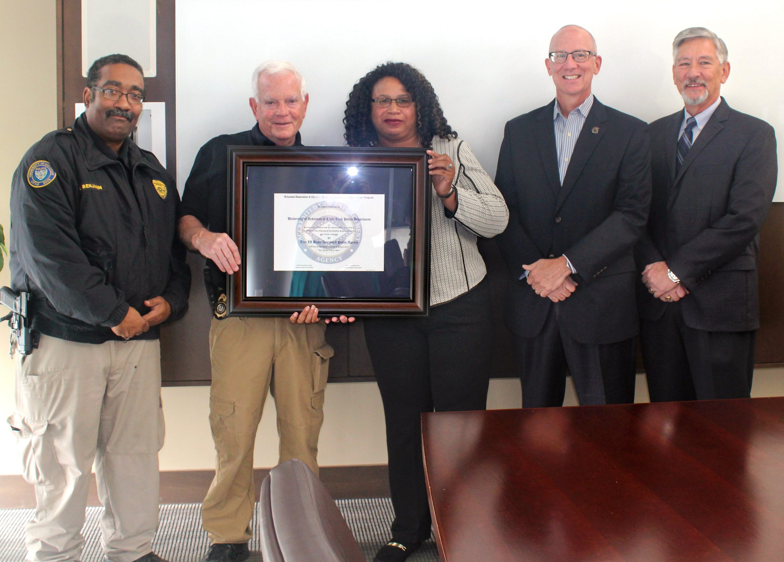 Pictured, from left to right, are UA Little Rock Assistant Police Chief Rommel Benjamin; UA Little Rock Former Police Chief Brad King; UA Little Rock Police Chief Regina Wade-Carter; Dr. Jerry Ganz, vice chancellor for finance and administration; and Gary Sipes, executive director of the Arkansas Association of Chiefs of Police. Photo by Angie Faller.