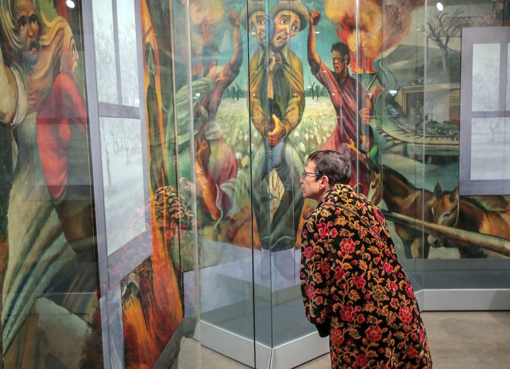 Visitors to the UA Little Rock Downtown Center participate in a program discussing the Joe Jones mural on display. Photo by Ben Krain.