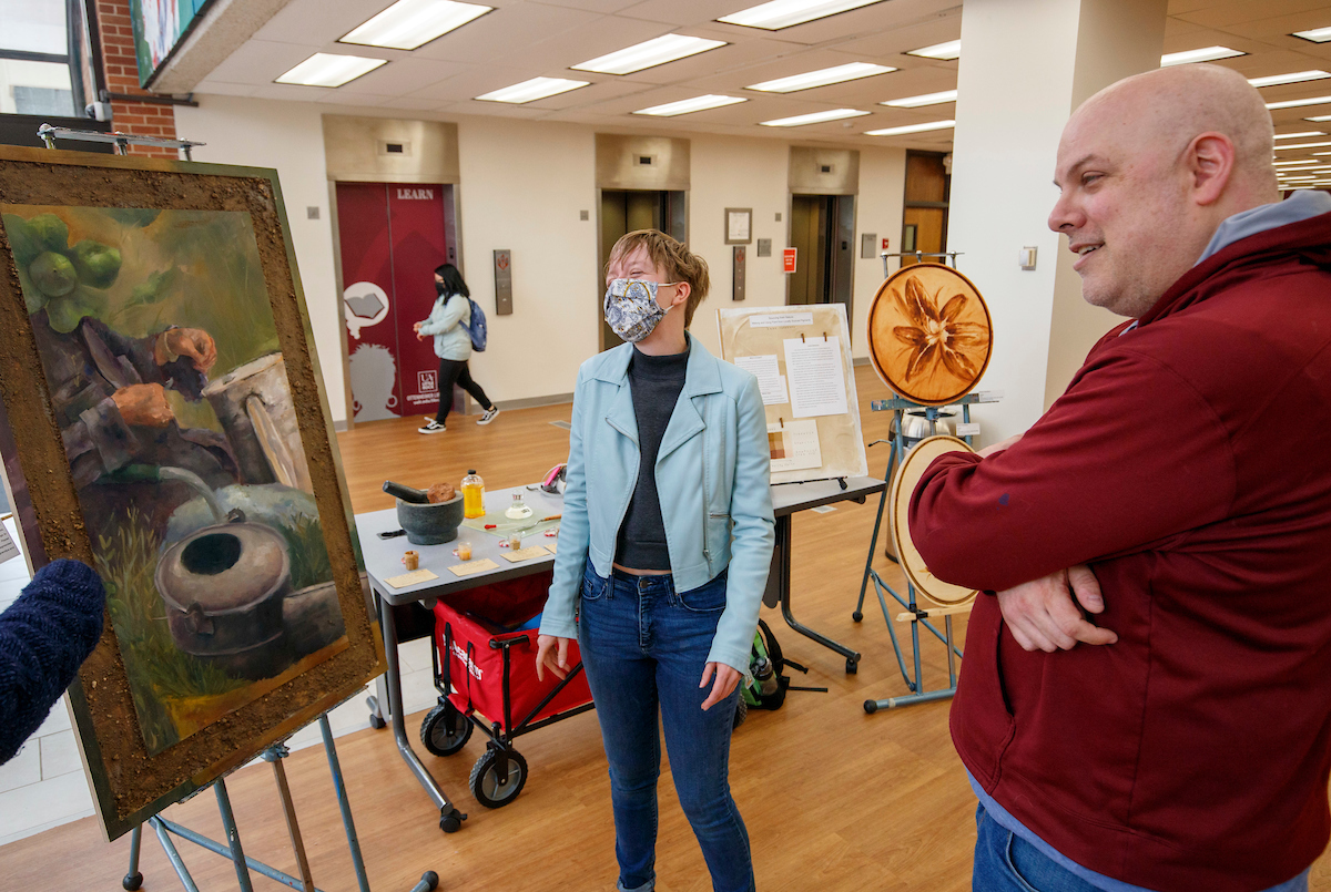 Emma Chambers showcases her homemade paint during the 2022 Student Research and Creative Works Expo.