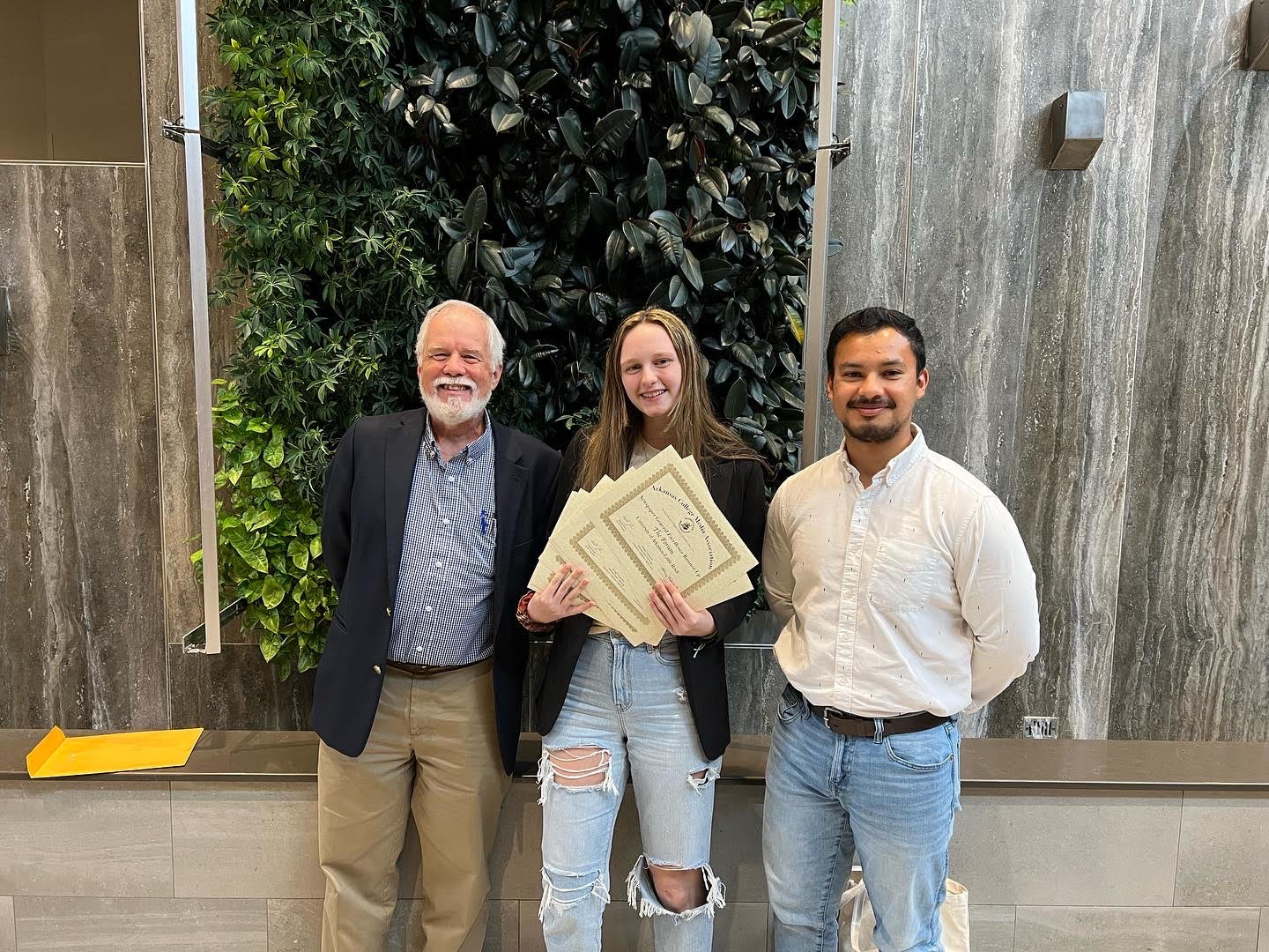 Professor Sonny Rhodes celebrates with students Chloe McGehee and Bryan Hernandez!