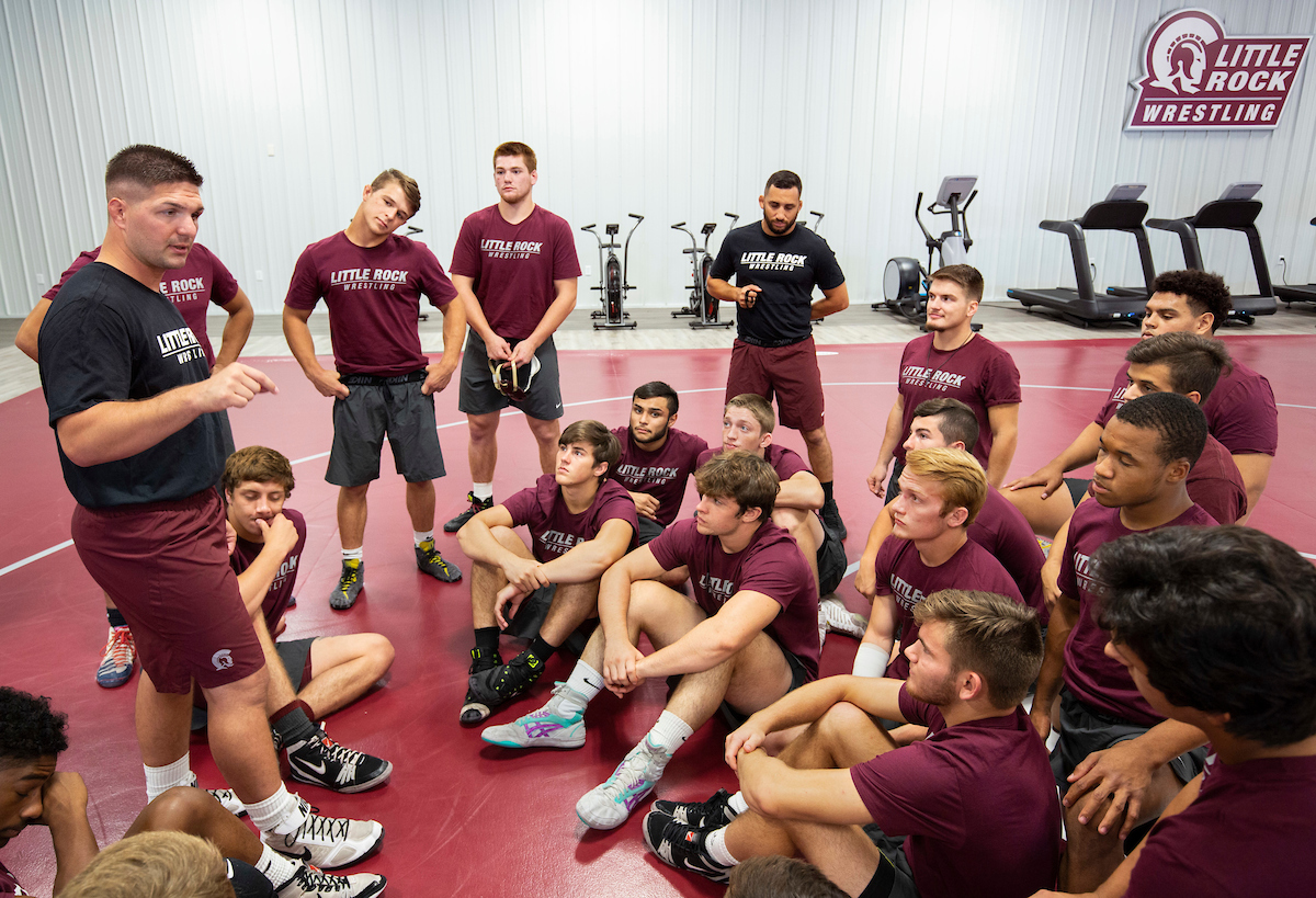 UA Little Rock wrestling coach Neil Erisman, left, talks to his team during a workout.