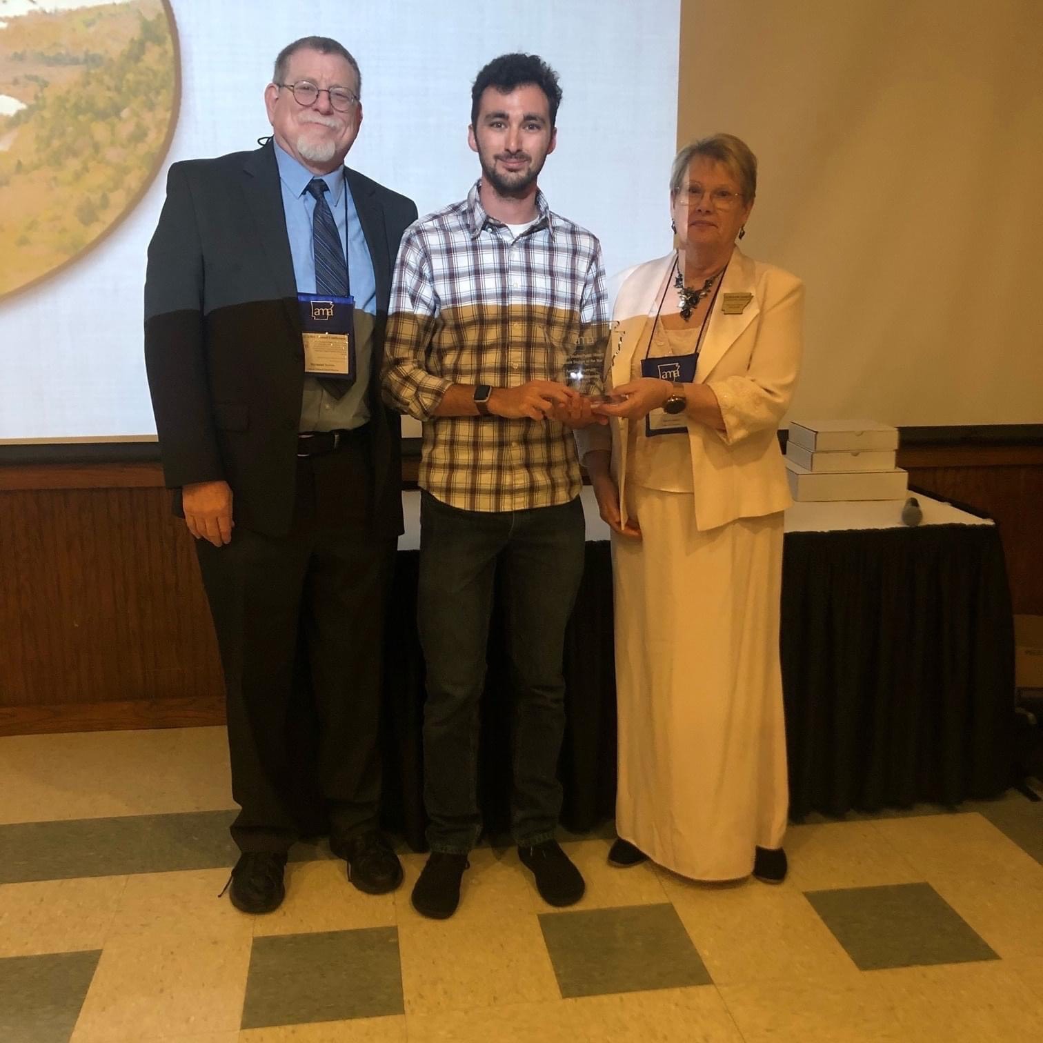 Aaron Shuman, a 2021 graduate of the University of Arkansas at Little Rock, receives the 2022 Public History Graduate Student of the Year Award from the Arkansas Museums Association.