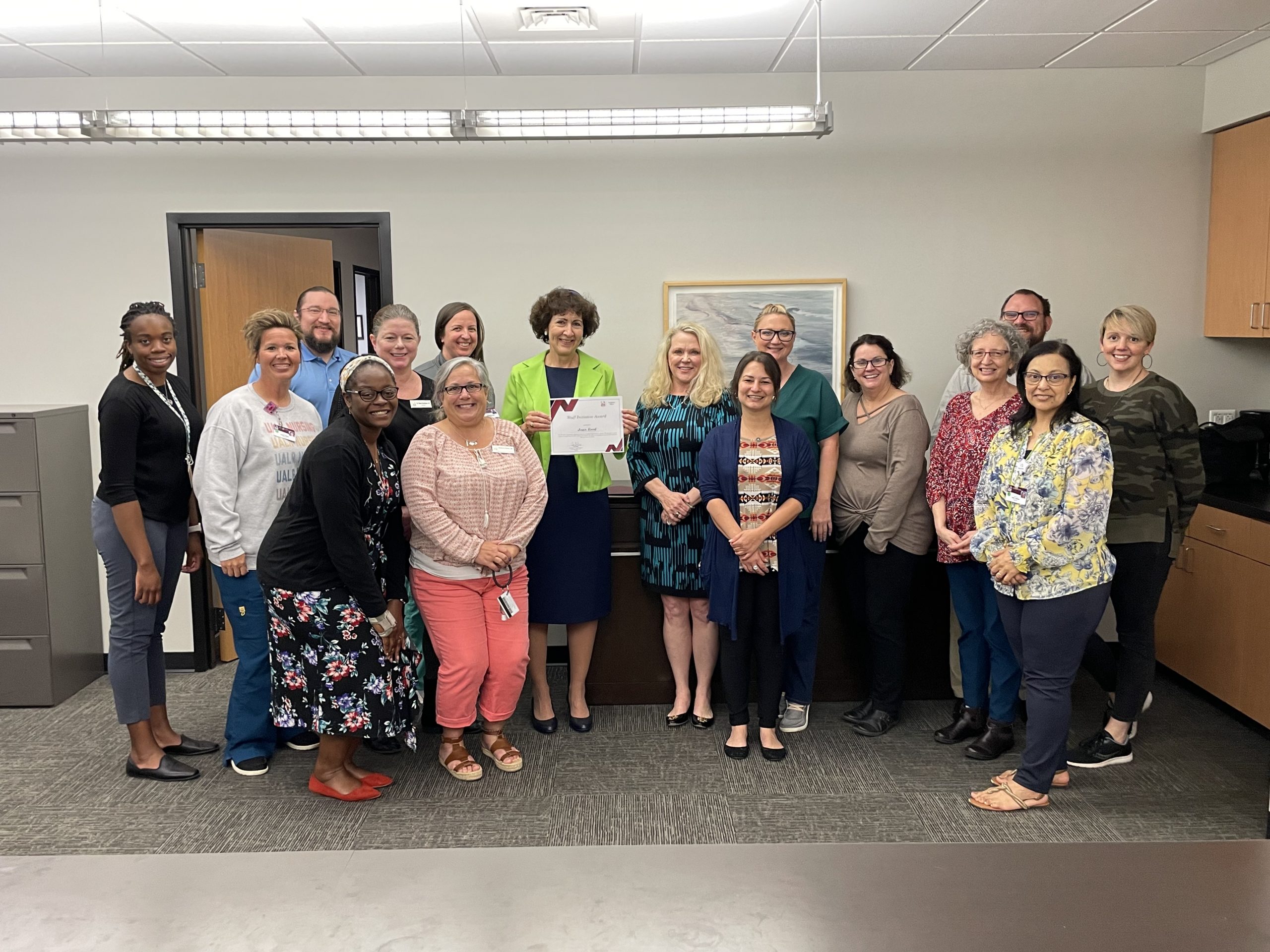 Provost Ann Bain presents Joan Reed with the Staff Recognition Award for Initiative.