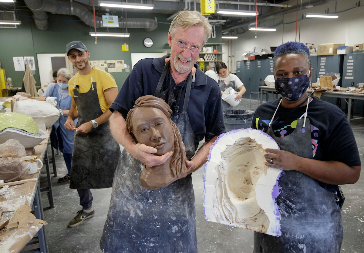 UA Little Rock sculpture instructor Michael Warrick helps a participant in his artWAYS summer sculpture workshop for art teachers.