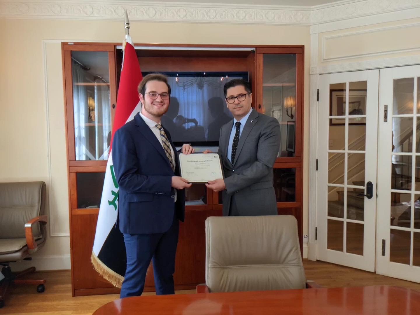 Dr. Salwan Sinjaree, the U.S. ambassador to Iraq, presents UA Little Rock student Caleb Mimms with a certificate for his service as a summer intern for the Embassy of the Republic of Iraq in Washington, D.C.