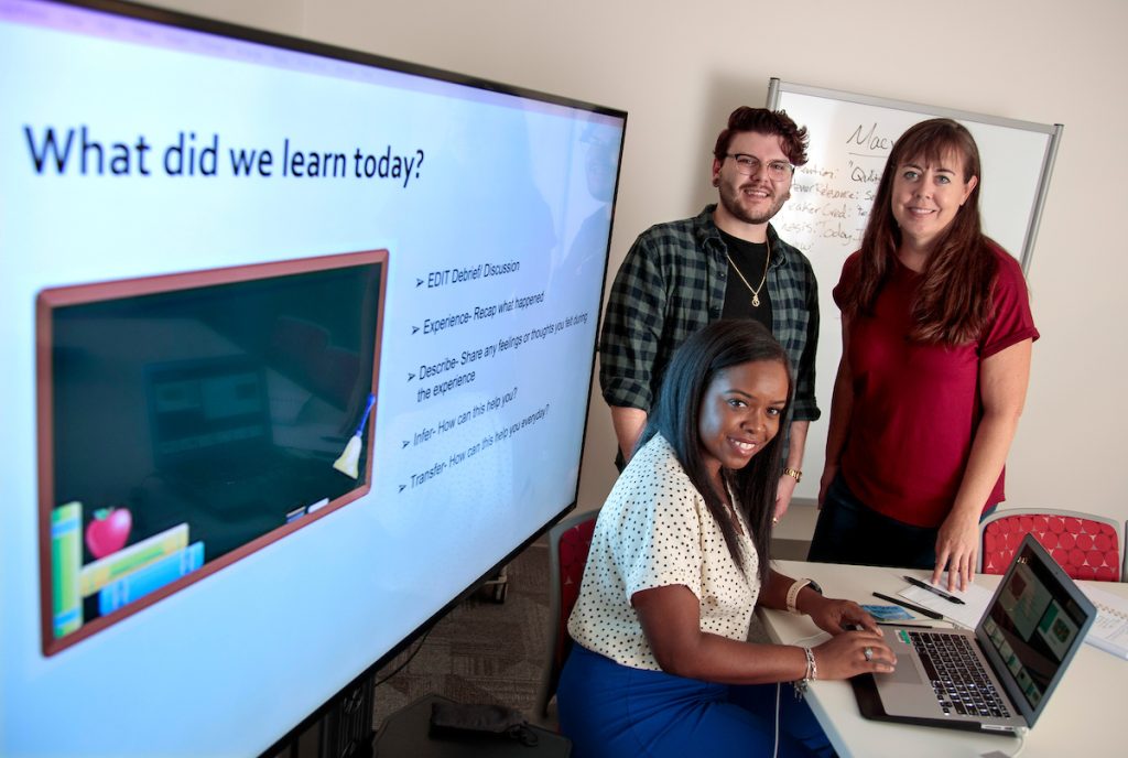 Learning Commons Coordinator Brandon Solllars and Michelle Malone and De’Ja Johnson, applied communication graduate students, give a presentation  In the Communications Skills Center in Ottenheimer Library. Photo by Ben Krain.