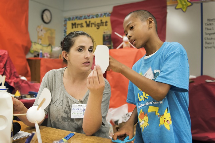 A SLUFY instructor teaches gifted children the finer points of making windmills in the SLUFY program.
