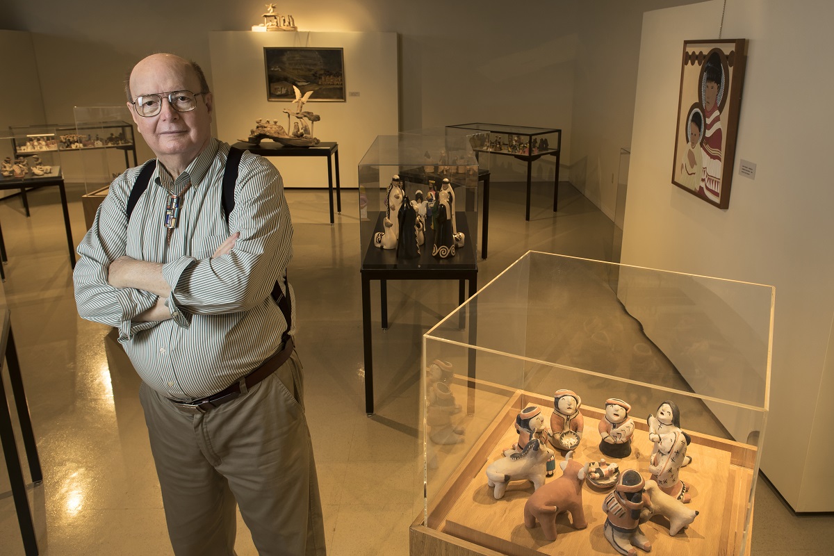 Dr. Bill Wiggins at UALR's Sequoyah National Research Center on Wednesday, Aug. 5, 2015, stands among his collection of Nativity scenes from around the world