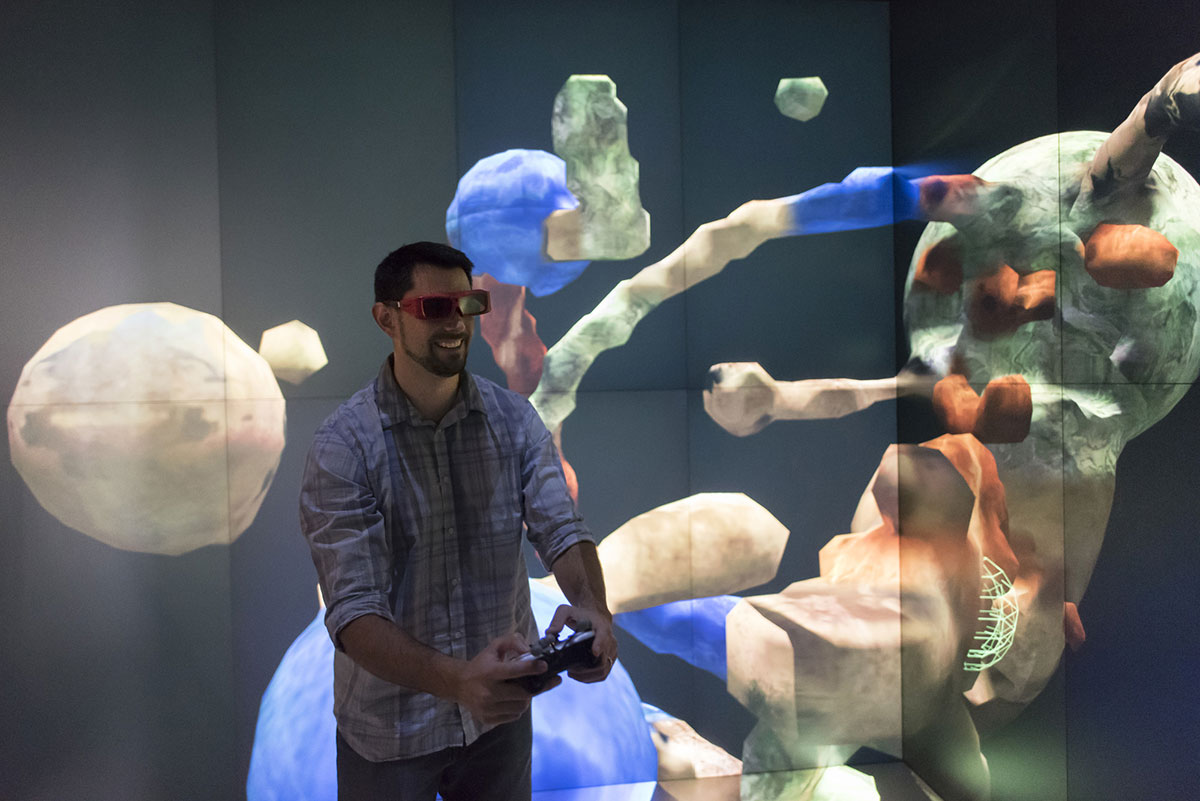 An EAC staff member demonstrates some of the center's virtual technology capabilities