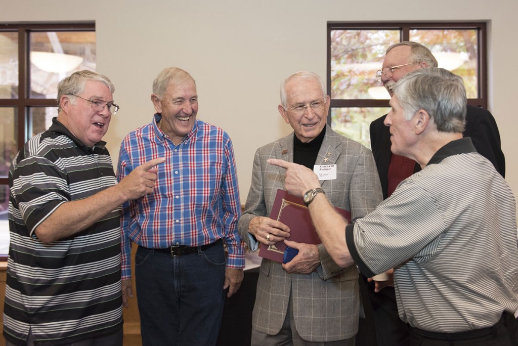 Coach Ballard shares a light moment with some of his basketball players from the 1960s