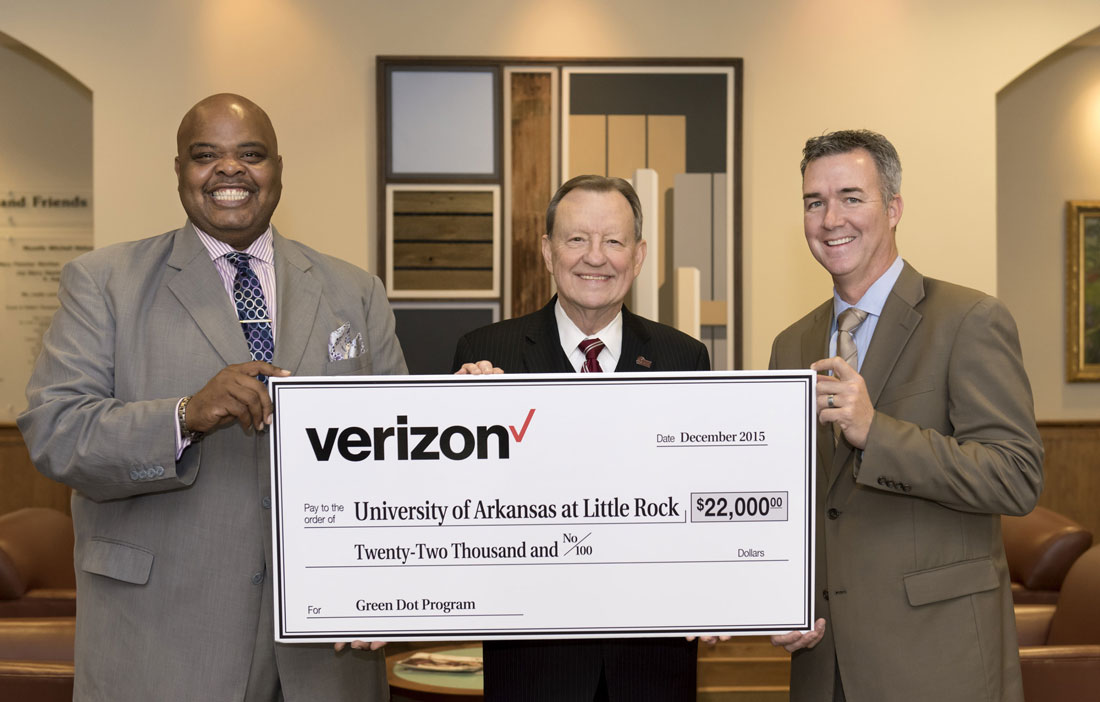 Schawnee Hightower, associate director of strategic sales at Verizon, University of Arkansas at Little Rock Chancellor Joel E. Anderson (center) and Patrick Lee, Verizon associate sales director hold a giant check representing a $22,000 donation to UALR's Green Dot program