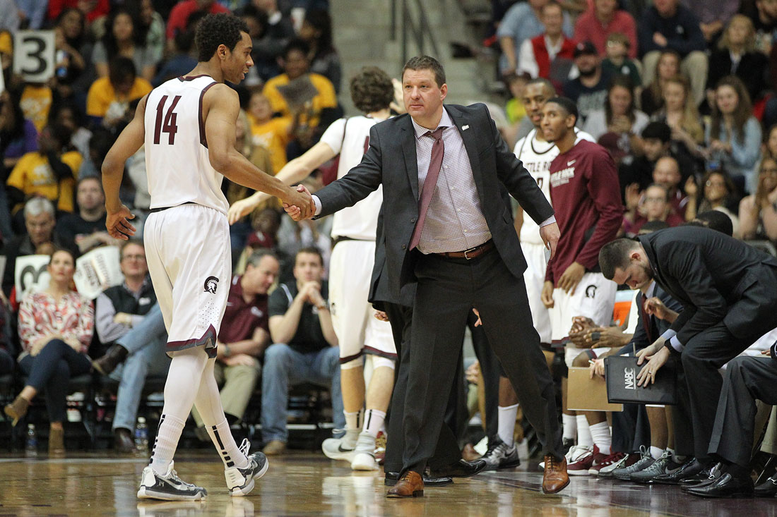 Trojans men's basketball Coach Chris Beard shakes a player's hand during a recent game
