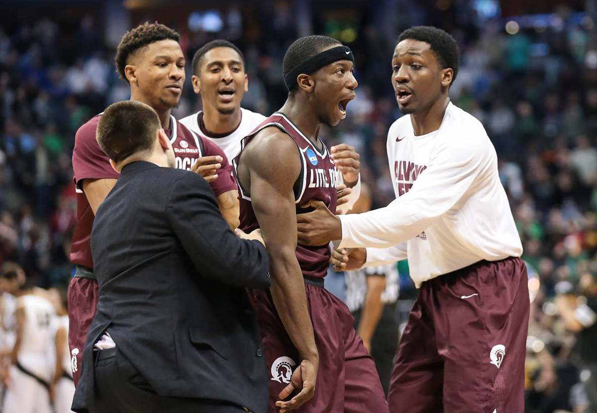 Trojans players celebrate during their NCAA match-up with Purdue