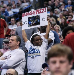 A Trojans fan holds up a Hagins 4 Prez sign