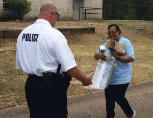 Janice White (right) and a police officer prepare for the 2015 National Night Out event. 