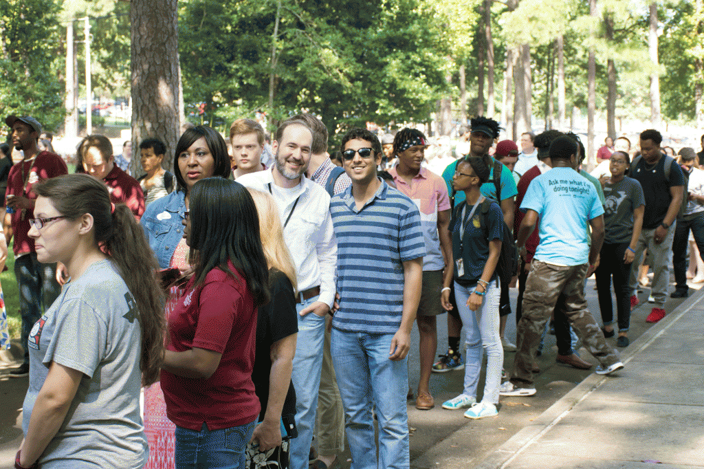 People line up to get a free meal during BBQ at Bailey Sept. 14 at Bailey Alumni and Friends Center. 