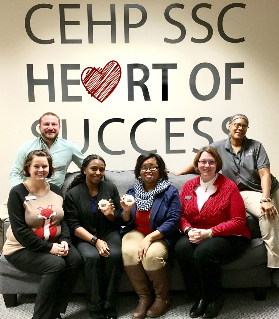 Member of the UA Little Rock College of Education and Health Professions Student Success Center receive cookies for their participation in the 2016 employee giving campaign. 
