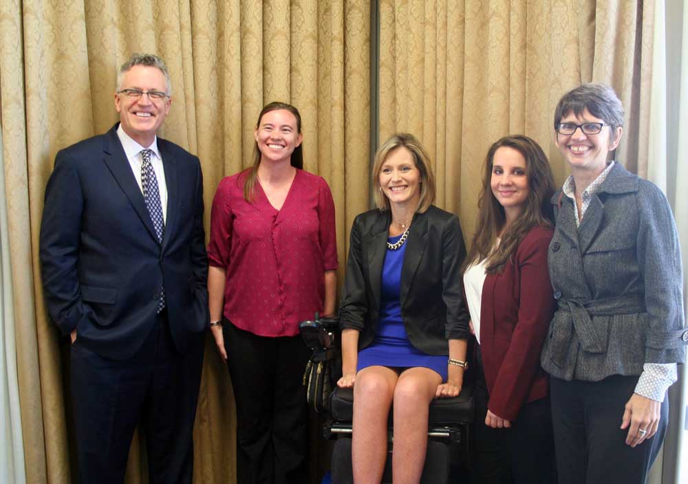 Pictured, from left to right, are Michael Hunter Schwartz, dean of the Bowen School of Law; scholarship winners Nicole Winters, Jennifer Goodwin, and Nicole Paladino; and Theresa Beiner, associate dean for academic affairs at Bowen. Photo by Nick Popowitch/Daily Record.
