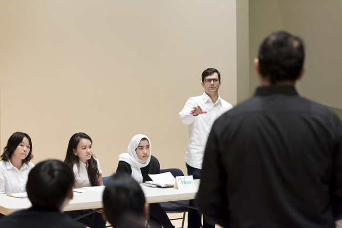 UA Little Rock students Zheng Zhang, Tho Nguyen, Weam Felimban, and Rodrigo Luizetto offer a rebuttal to opposing team captain Ahmad Sales in the Intensive English Language Program debate on Nov. 21, 2017.