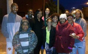 Tanice Blackman and her friends and family members tie scarves for the homeless around light poles in downtown Little Rock in December 2016. 