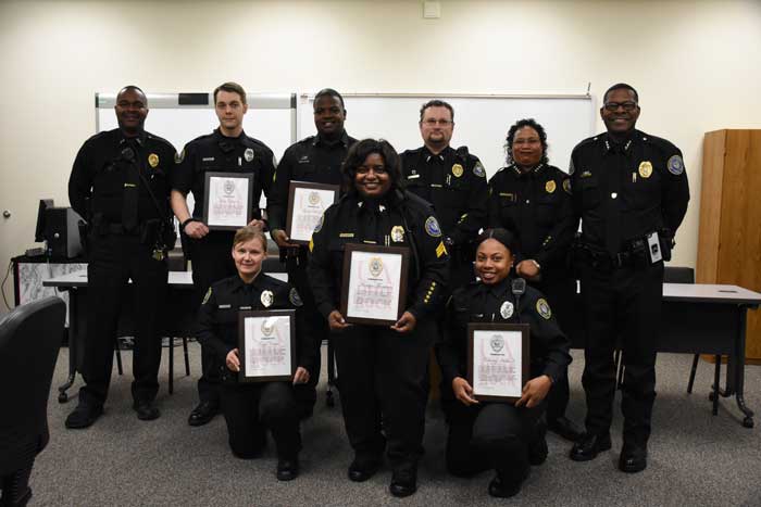 UA Little Rock police officers receive a commendation during a Feb. 2 ceremony for their heroic efforts to save a man’s life during a Jan. 2 call. Back row (L to R) include Lt. Jerome Bailey, Officer John Claunch, Cpl. Gary McGee, Lt. Aaron Birmingham, Chief Regina Wade-Carter, and Assistant Chief Johnny Smith. Front row (L to R) include Det. Tonya Carter, Sgt. Marilyn Thompson, and Officer Deshalay Hubbard.