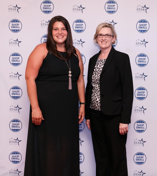 Laura Fine, ASBTDC state director, congratulates 2018 State Star Whitney Horton (left).