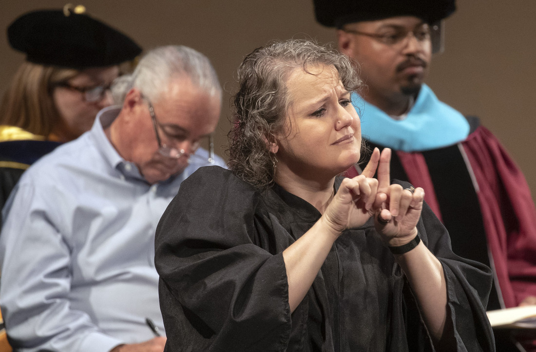Sign language interpreter Gwenyth Sutphin translates during a freshmen convocation event.