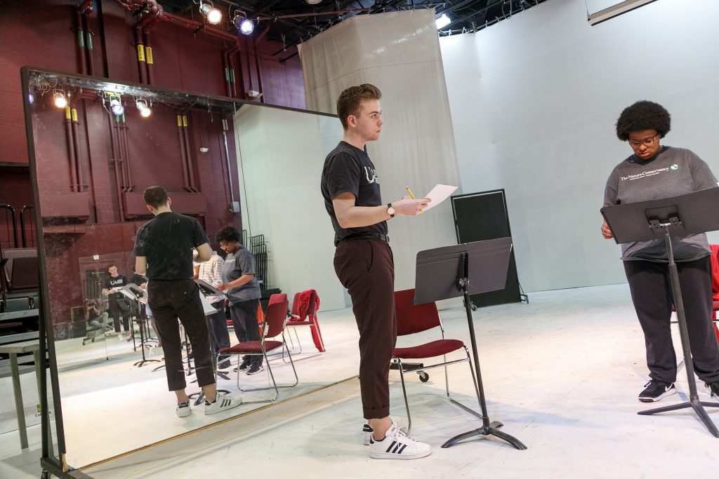Sophomore theatre major and Donaghey Scholar, Gage Pipkin, rehearses a reading of his play with four student actors. Photo by Ben Krain.