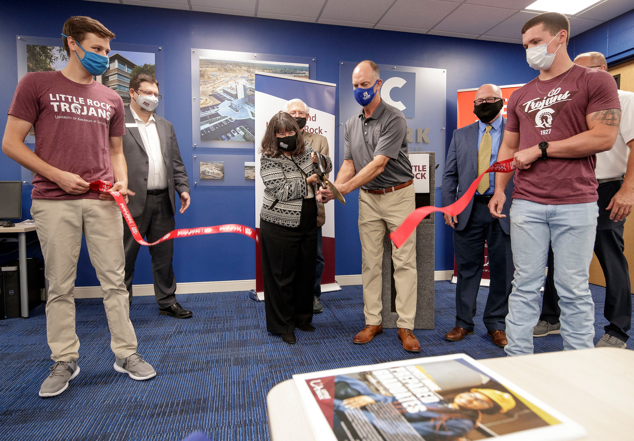 UA Little Rock Chancellor Christy Drale, center left, and Clark Contractors CEO William Clark, center right, cut a grand opening ribbon at an event dedicating a construction management classroom on campus on Sept. 10. Photo by Ben Krain.