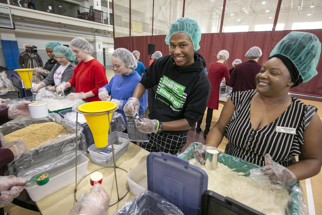 UA Little Rock students, faculty, and staff fill ready-to-cook meal bags during a Feed-the-Funnel philanthropy event facilitated by The Pack Shack hunger relief charity. Participants made 10,000 meals which will be donated to the Trojan Food Pantry. Photo by Ben Krain.