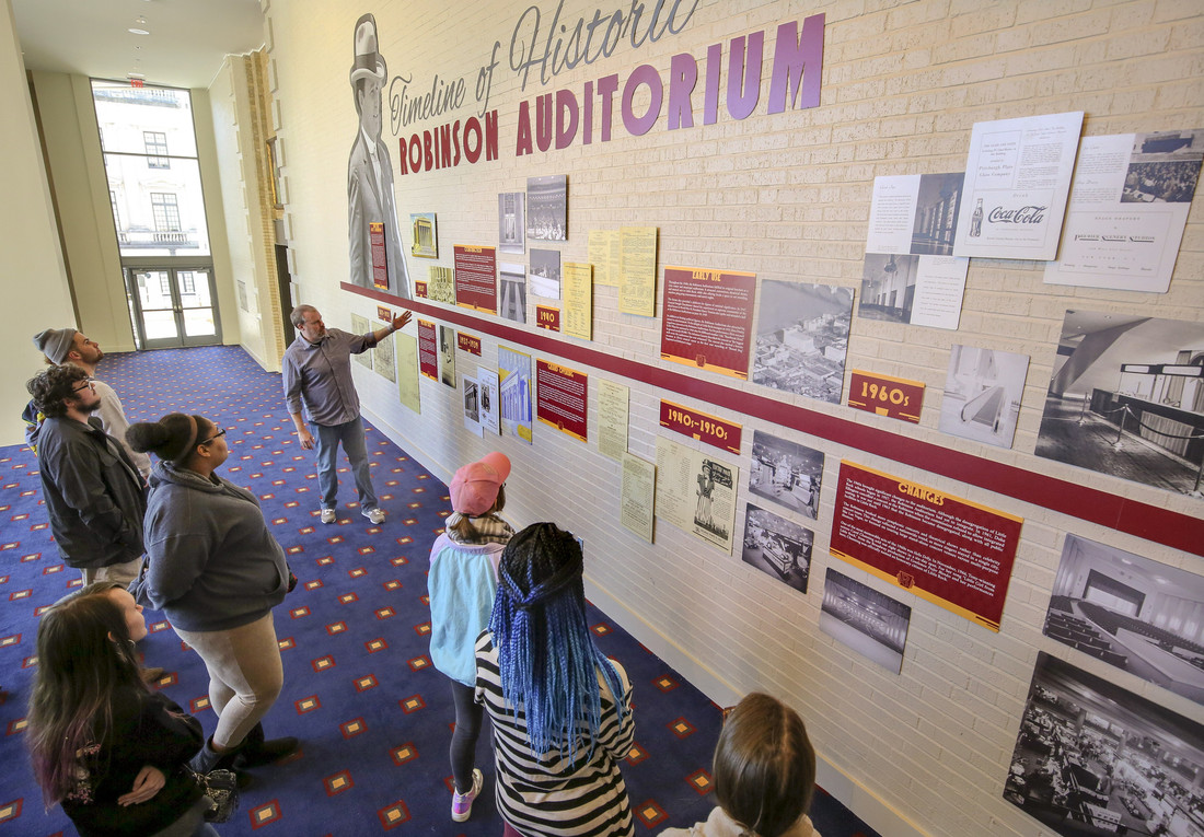 Photo of students visiting the historic timeline exhibit at Robinson Auditorium